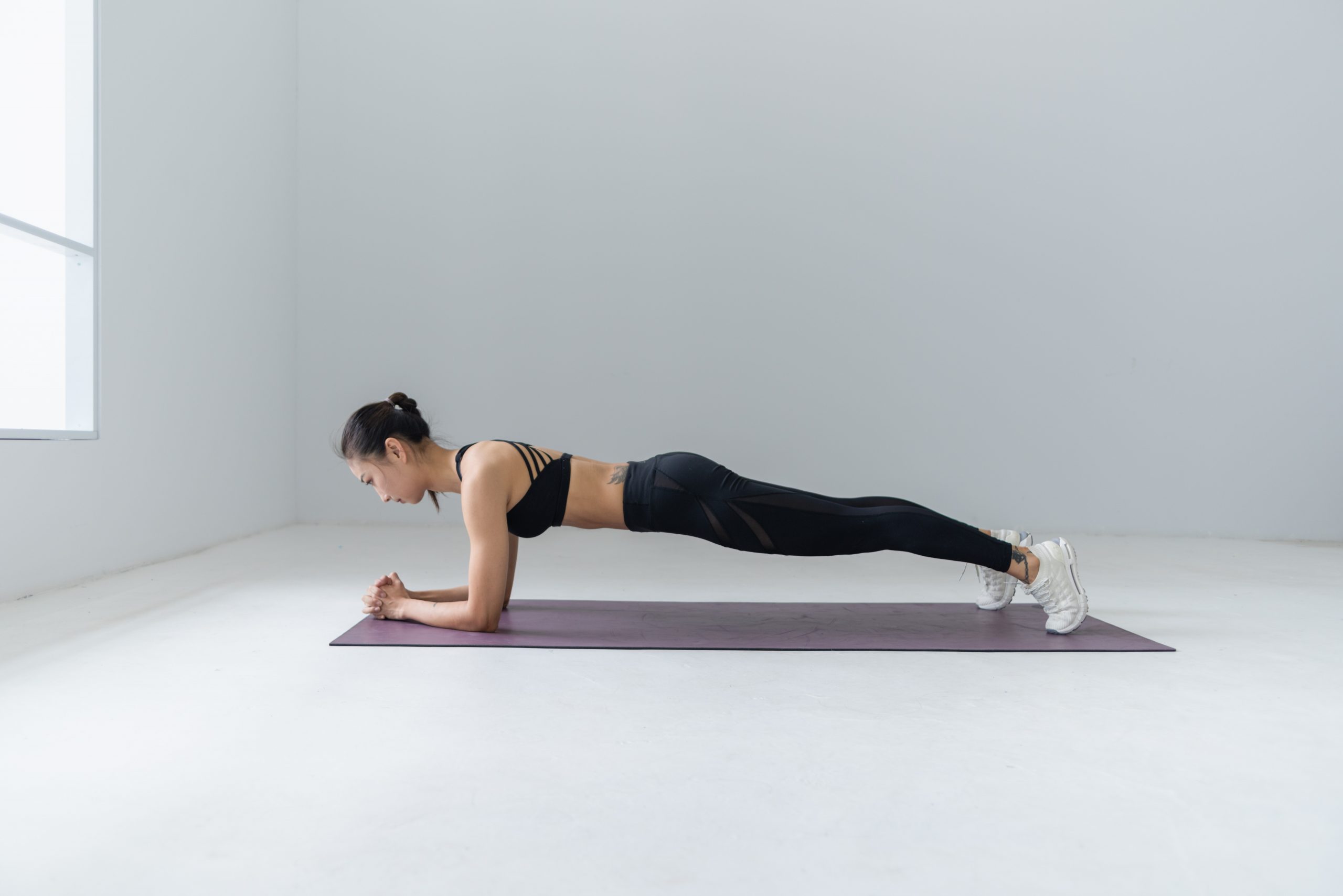 A woman holding forearm plank position